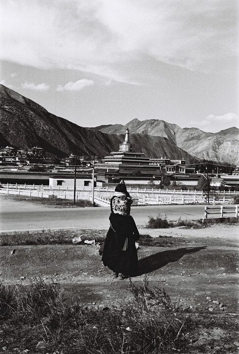 Woman praying towards the Labulen Temple. Xiahe, Gansu<br />