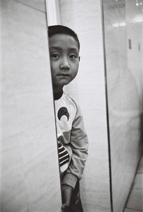 Shy boy in a barbecue shop. Xi'an, Shanxi<br />