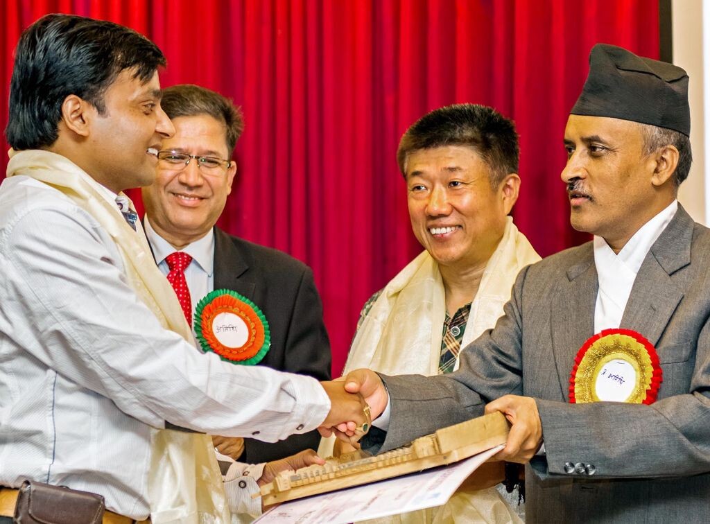 01. Nepali Photographer Om Prakash Yadav (Left) being awarded by Chief Secretary Lila Mani Poudel during a function organized by National Tourism Federation on the eve of  34th World Tourism Day at NTB, Kathmandu on Thursday. also seen in the picture is Chinese Photographer Su Xue (2nd from R) and acting CEO of NTB Suvash Niraula. Xue was also honoured for promoting tourism among Chinese tourists thru his pictures of Nepal.