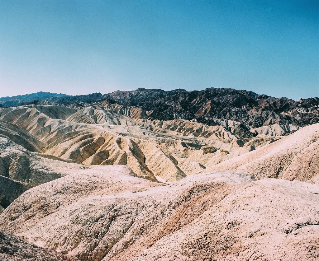Death Valley is a desert valley located in Eastern California's Mojave Desert, the lowest, driest, and hottest area in North America.<br />
<br />
<br />
<br />
Death Valley's Badwater Basin is the point of the lowest elevation in North America at 282 feet (86 m) below sea level. This point is 84.6 miles (136.2 km) east-southeast of Mount Whitney, the highest point in the contiguous United States with an elevation of 14,505 feet (4,421 m). Death Valley's Furnace Creek holds the record for the highest reliably reported air temperature in the world, 134 °F (56.7 °C) on July 10, 1913.<br />
<br />
<br />
<br />
Located near the border of California and Nevada, in the Great Basin, east of the Sierra Nevada mountains, Death Valley constitutes much of Death Valley National Park and is the principal feature of the Mojave and Colorado Deserts Biosphere Reserve. It is located mostly in Inyo County, California. It runs from north to south between the Amargosa Range on the east and the Panamint Range on the west; the Sylvania Mountains and the Owlshead Mountains form its northern and southern boundaries, respectively. It has an area of about 3,000 sq mi (7,800 km2).The highest point in Death Valley itself is Telescope Peak in the Panamint Range, which has an elevation of 11,043 feet (3,366 m)