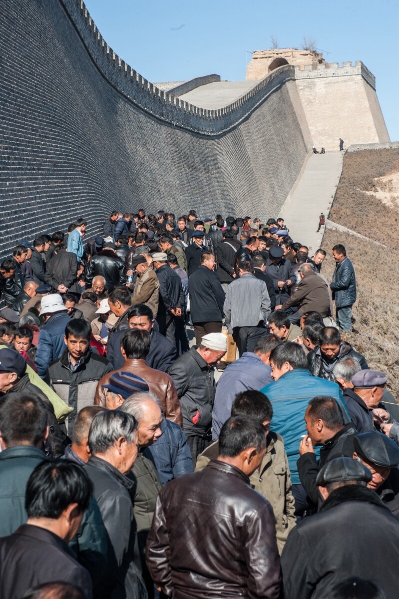 2015年3月9日陕西榆林,当地人在新维修的城墙下聊天打牌下棋娱乐。