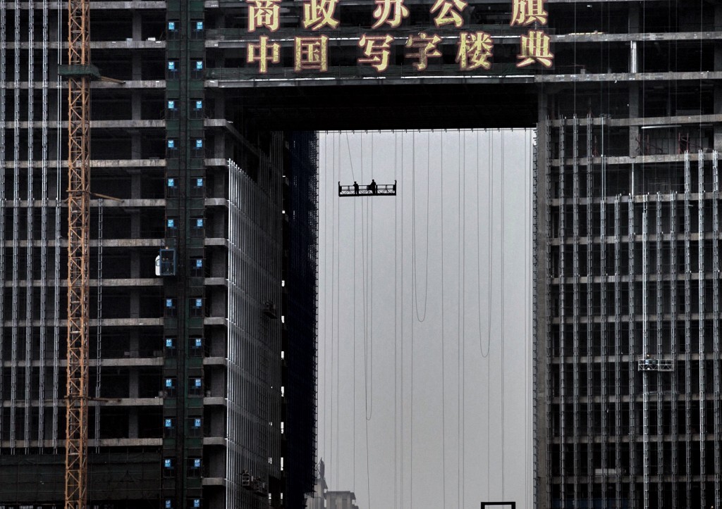 2013年4月,重庆渝北区红锦大道,建设中的康田凯旋国际写字楼。山寨凯旋门造型的这栋大楼,现在是当地地标。