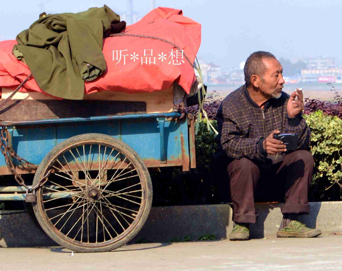 一位收废品的老汉,走累了,在路边休息一下.