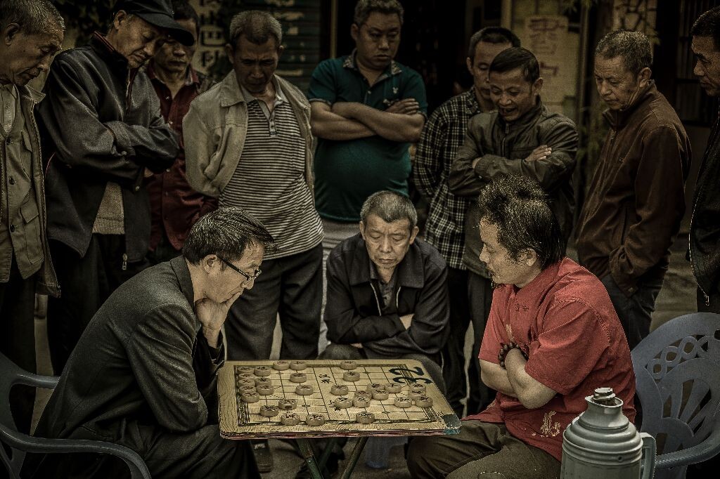 清晨的街边，两位高手摆开擂台激战正酣，围观的市民表情各异，丝毫未发觉我镜头正对准他们...