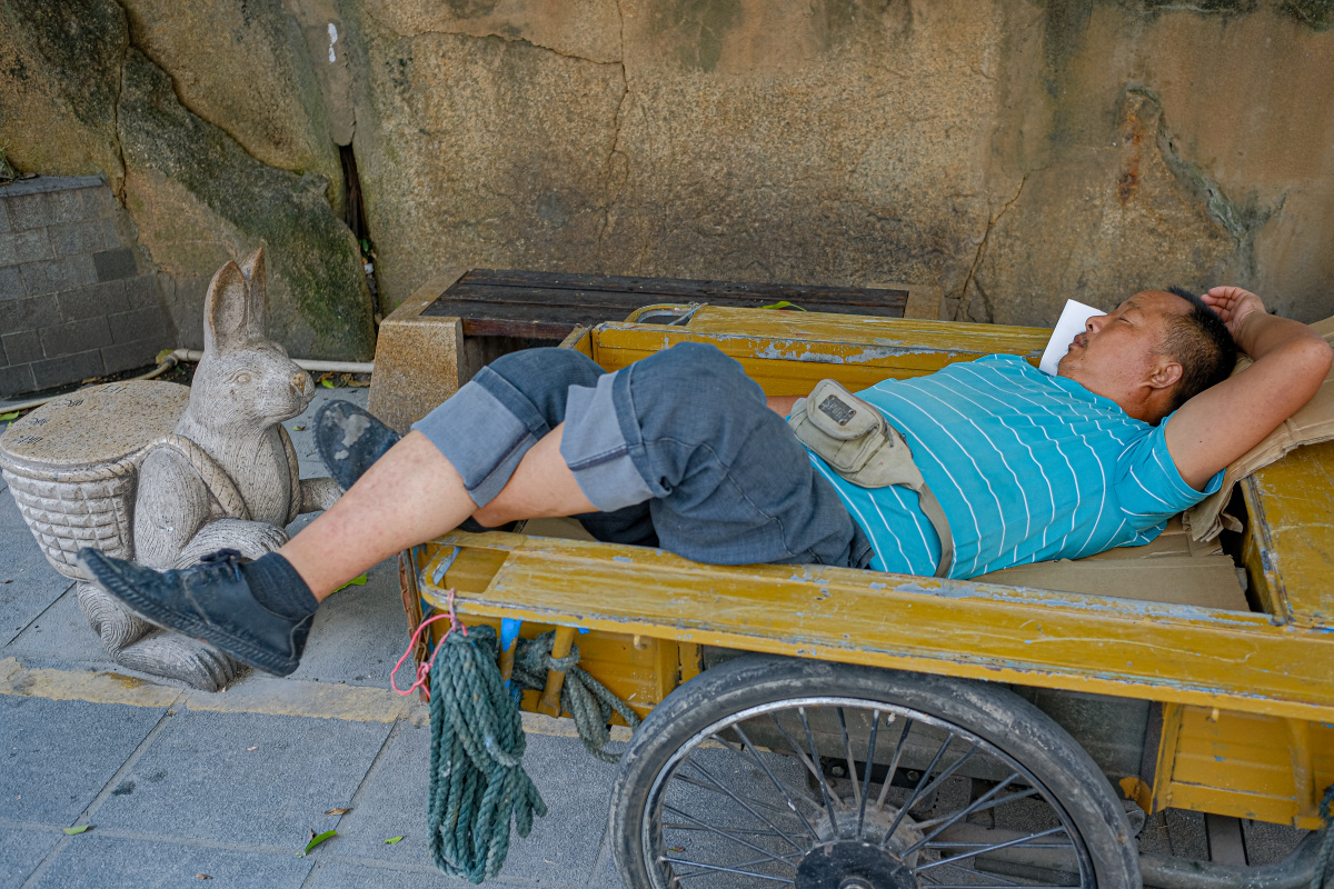 摄于福建省厦门市街头.在自己的三轮车上休息的农民工.