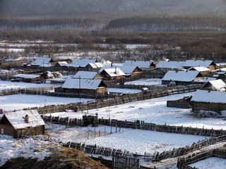 东北，大兴安岭林区，用木栅栏围着的雪乡村庄