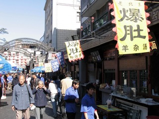 北京王府井小吃街：消费者熙熙攘攘的小吃街，老北京“爆肚”的字号旗在飘扬（摄于2004年11月）