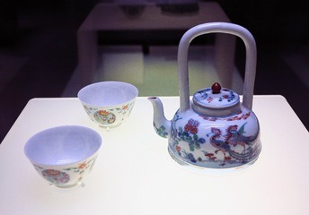 斗彩团菊纹杯（左），斗彩五伦图提梁壶（右），清朝雍正年间瓷器，北京首都博物馆文物展。