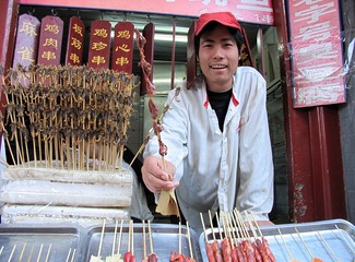 北京王府井小吃街：烧烤店的厨师向顾客推销羊肉串。（摄于2004年11月）