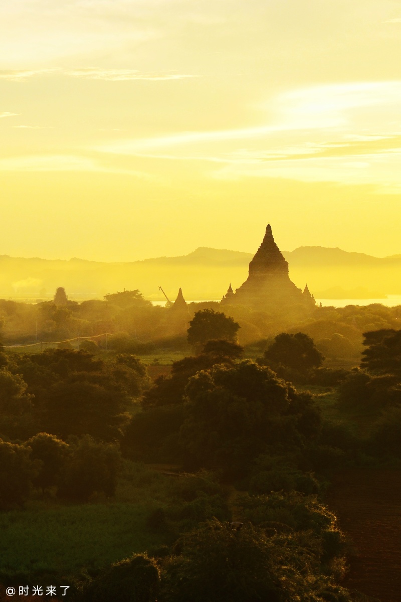 黎明时的缅甸蒲甘日出的金光撒在佛塔上若隐若现