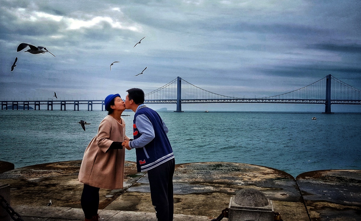 一对热恋中的青年男女,在大连星海湾广场以大海,大桥为背景,面对广场