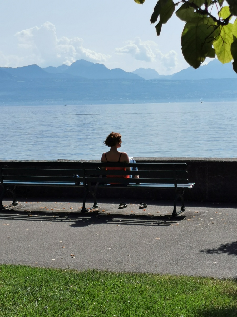 沉思瑞士洛桑风光秀丽的湖畔少女独坐望着湖水远山