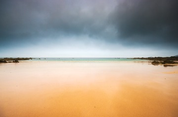 Empty beach and dark sky