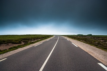 empty road with dark clouds
