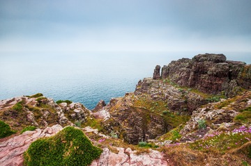 Rocks and see in hazy day