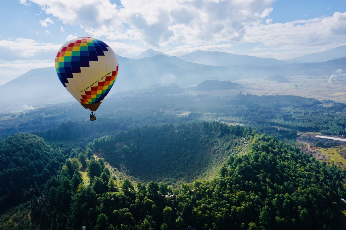 腾冲五颜六色的热气球在大小空山上方徐徐升起远处便是那世界基因库