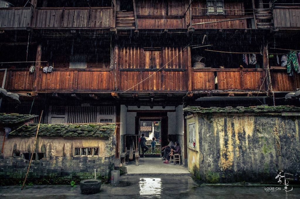 遲暮<br />
他們日復一日坐在門後的石凳上，看遊客熙來攘往，看門前車水馬龍，思想可關紅塵？於福建漳州南靖土樓。