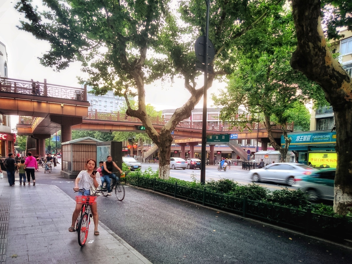 杭州解放路天桥连接着横跨城市的南宋御街,而在桥下是个骑着共享单车