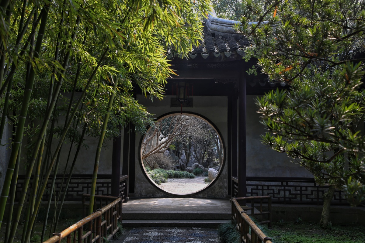 留园里透过圆形的门洞能看到另一处空间的景色巧妙地因借