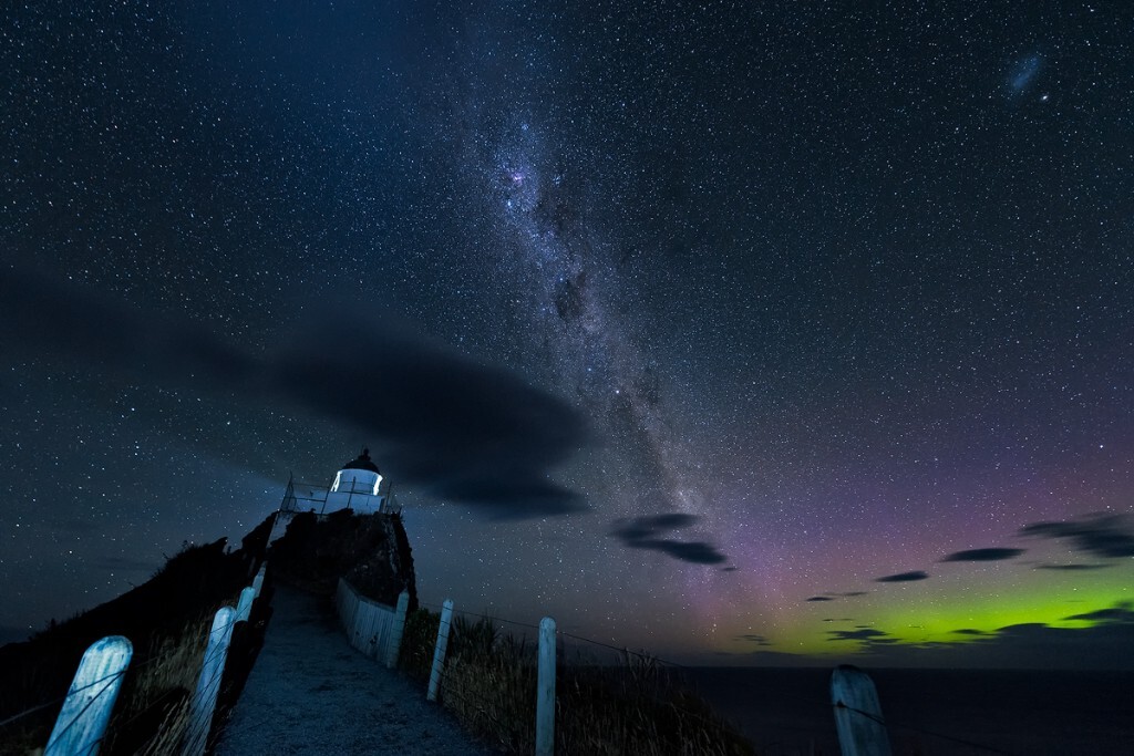 A surprising glimpse of southern light appearing when enjoying the Milky Way over the Nugget Point Lighthouse.