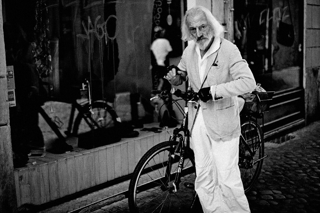A silver haired man with a bike 推着自行车的银发老头