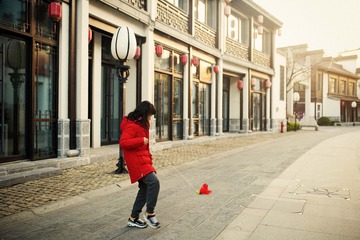 A girl is kicking shuttlecock