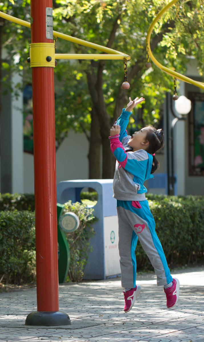 小姑娘腾空而起,伸手够向小球的刹那间.