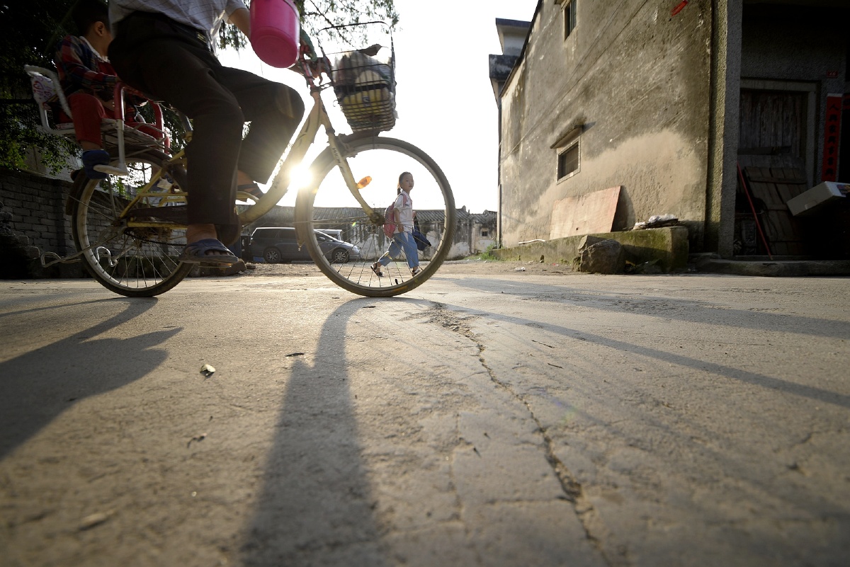 摄于广东省汕头市澄海区程洋岗古村,傍晚,小学生放学回家,有