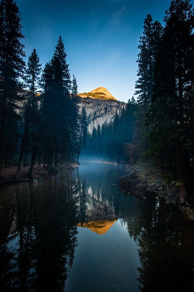 倒影<br />
从mirror lake徒步回停车场的途中 路过一个拱桥 随机看到此景 用相机记录下来 日落时分，山顶被映照成金色，水面平静，雾蒙蒙的水汽增添了一丝神秘。<br />
来不及拿脚架，光影总在一瞬间。。。