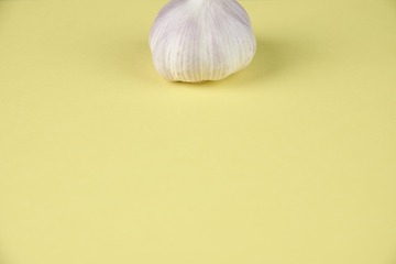 a garlic on yellow paper