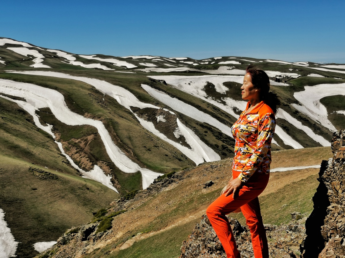 迷彩山与红衣女拍摄于新疆塔城裕民县阿克乔克草原