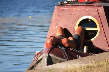A man relaxing lay on a boat 