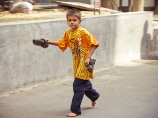 Holding shoes walk boy