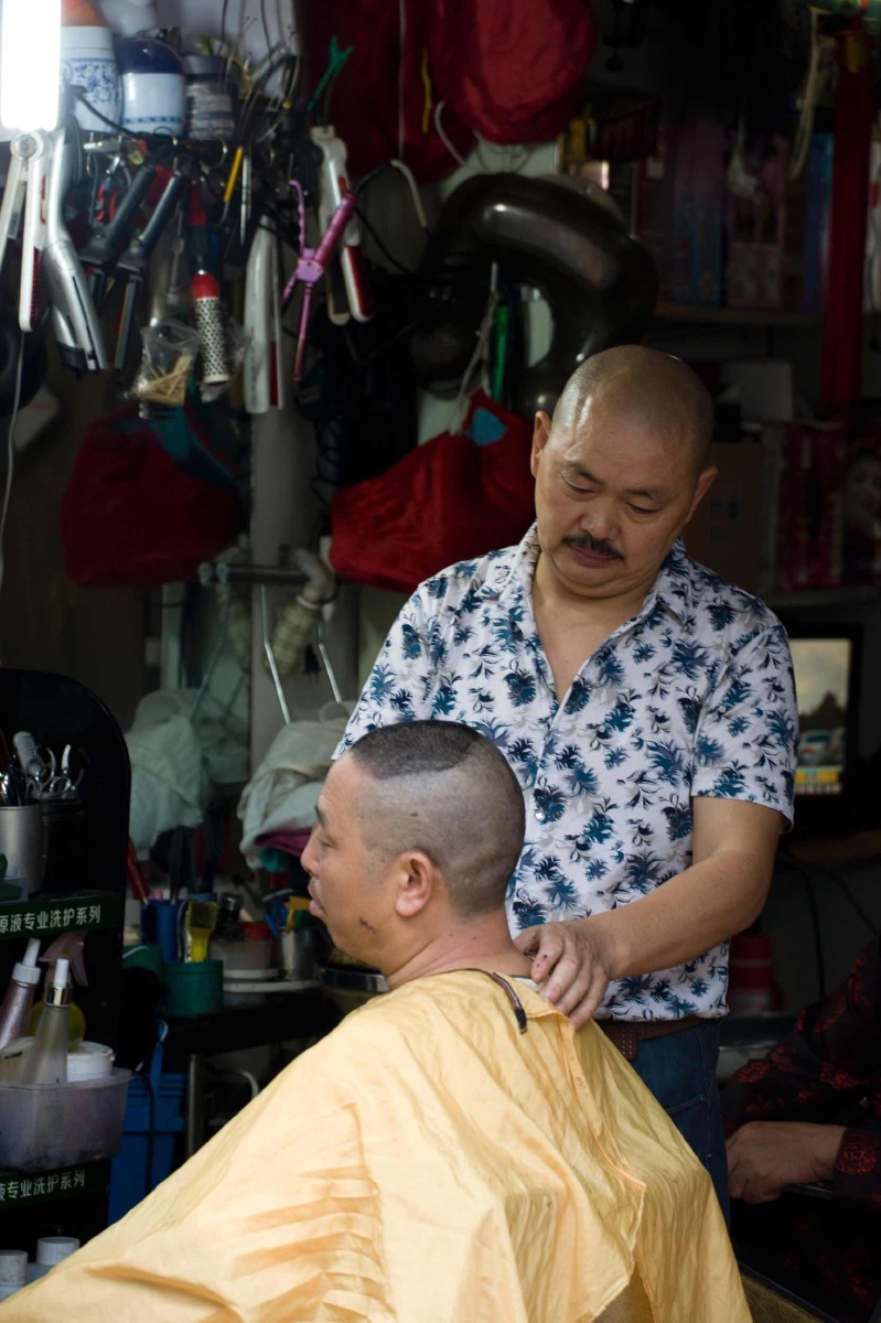 本人路过此地见理发美容师正在为顾客理发,见到此场景便很快拍下了此