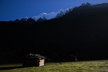 Pasture under snow peak