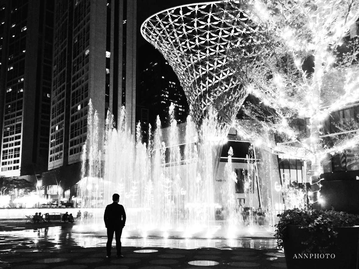 城市里的孤独感摄影ann偶遇一个站在繁华城市喷泉边的发呆的人这一个